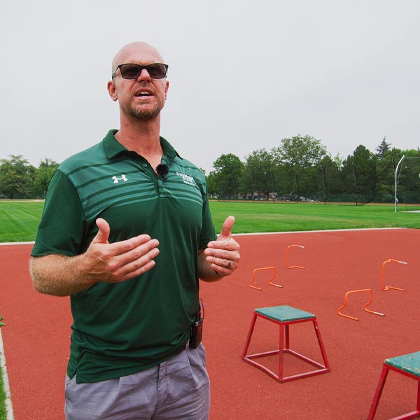 coach teaching high jump box drills